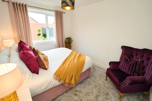 a bedroom with a bed and a chair and a window at Chic Family Home with Garden Fire Pit & Event Space, Hot Tub in Manchester
