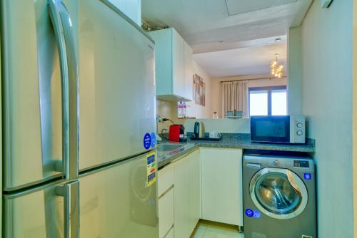 a kitchen with a washer and a washing machine at LOFTS by Elegant Hospitality in Cairo