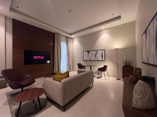 a living room with a couch and a tv at Rafa- Hittin in Riyadh