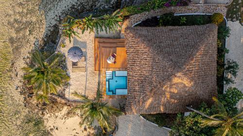 an overhead view of a house with a wooden door at Maharaja Boutique Hotel Zanzibar in Uroa