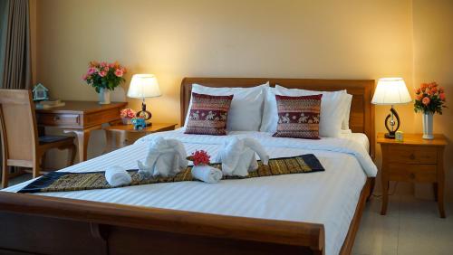 a bedroom with a bed with stuffed animals on it at Laph Kham House in Chiang Mai