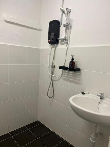 a bathroom with a shower and a sink at Aayu Seckchuan - 3 mins walk to Love Lane in George Town