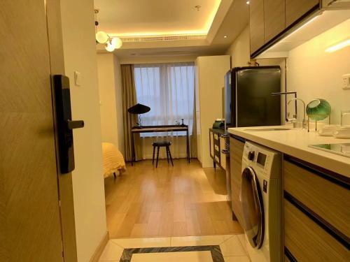 a kitchen with a washer and a sink and a piano at Shanghai Lerongju Boutique Apartment Metro Line 8 20meter in Shanghai