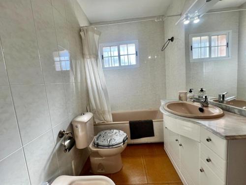 a white bathroom with a sink and a toilet at Escapada Bellavista 10 in Becerril de la Sierra