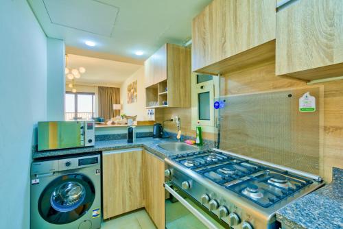 a kitchen with a stove and a sink at LOFTS by Elegant Hospitality in Cairo