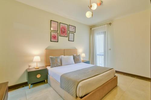 a bedroom with a large bed and a window at LOFTS by Elegant Hospitality in Cairo
