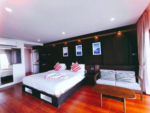 a bedroom with two beds with red and white pillows at Simple Life Cliff View Resort in Koh Tao