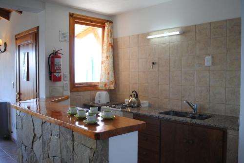 a kitchen with a counter top and a sink at Alun Bungalows Apart in San Carlos de Bariloche