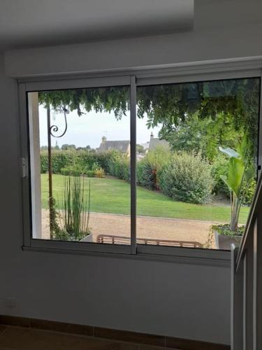 a window in a room with a view of a yard at Le Petit Ronsard in Flers