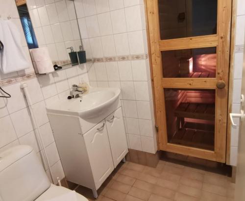 a bathroom with a sink and a toilet at Ahtinhovi in Ylivieska