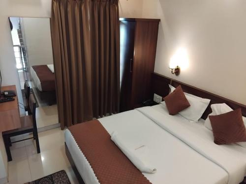 Ένα ή περισσότερα κρεβάτια σε δωμάτιο στο Hotel Assagao Grand