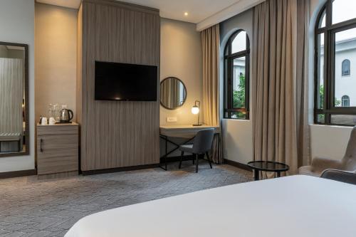 a hotel room with a bed and a desk at Radisson Lagos Ikeja in Lagos