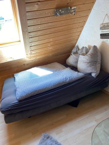 a bed sitting in a room with a window at Der Schmidthof in Todtmoos