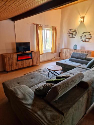 a living room with two couches and a tv at Chata Anna in Nižné Hágy