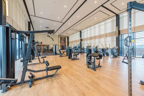 a gym with treadmills and exercise equipment in a building at Mossaz Premier Suites Damansara in Kampong Bukit Lanjan