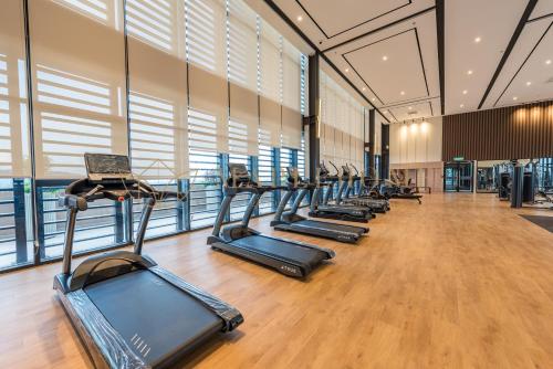 a row of cardio machines in a gym at Mossaz Premier Suites Damansara in Kampong Bukit Lanjan