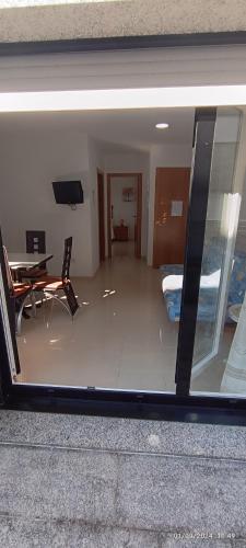 a view of a living room through a glass window at Hotel Brisa del Mar in O Grove