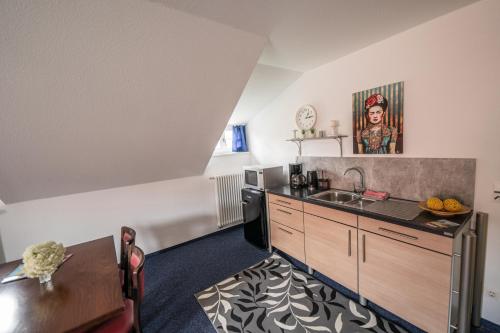 a kitchen with a sink and a counter top at Pension zur Postmeile in Bad Belzig