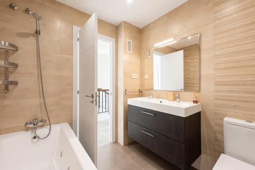 a bathroom with a sink and a shower and a tub at villa pedregalejo vista impresionante in Málaga