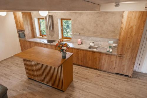 a bathroom with a sink and a counter with flowers at Sodyba "Baltalaukis" in Didžiosios Kabiškės