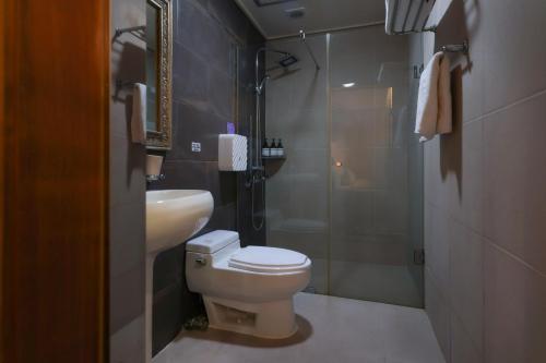 a bathroom with a toilet and a sink and a shower at New Day Hotel Gangnam in Seoul