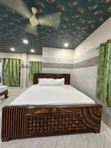 a bedroom with a large bed in a room at Hotel RPR grand in Narasaraopet