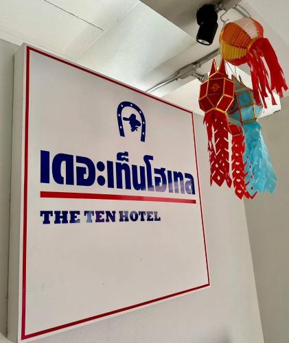 a sign hanging on a wall in a room at The Ten Hotel Thippanate in Chiang Mai
