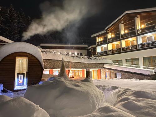 a large pile of snow in front of a building at Park Hotel Bellavista in Calalzo