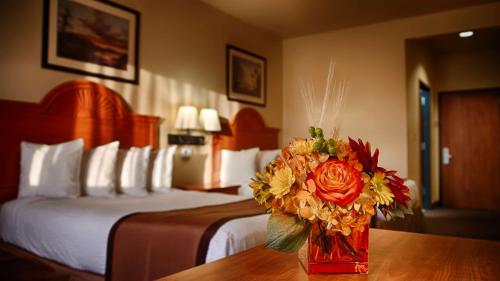 a vase of flowers on a table in a hotel room at Best Western Plus Graham Inn in Graham