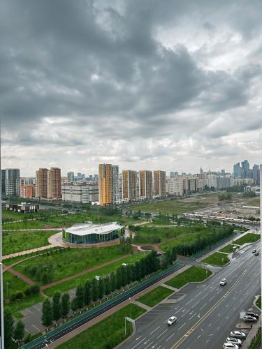 an aerial view of a city with a highway and buildings at Rio Inn hotel в районе EXPO in Astana