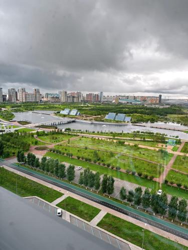 an aerial view of a park with a river and a city at Rio Inn hotel в районе EXPO in Astana