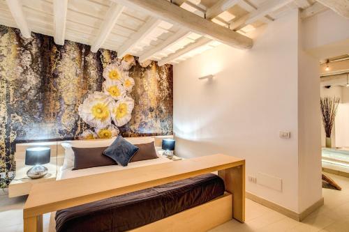 a bedroom with a bed with a floral wallpaper at YH Suite in Rome