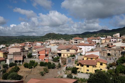 a group of houses in a town with mountains in the background at The Black Sheep BnB in Arbus