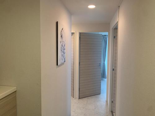 a hallway with a door leading to a bathroom at O2 capsule house OTARU in Otaru