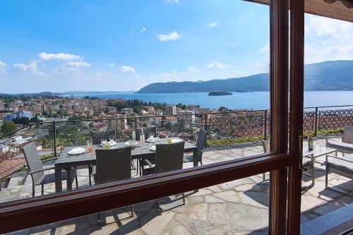 a table and chairs on a balcony with a view at Villa Vera in Verbania