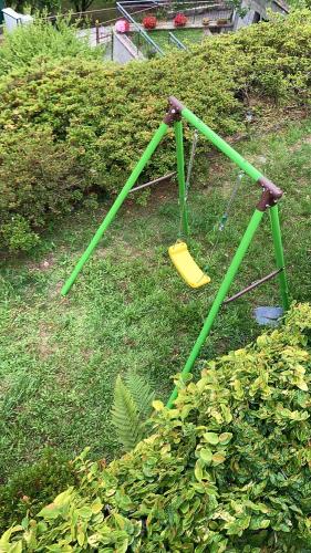 a swing set on the grass in a garden at Villa Vera in Verbania