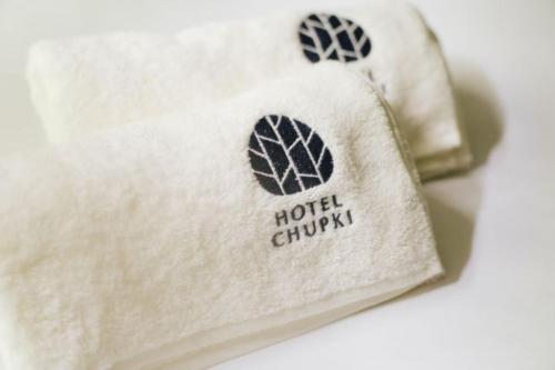 a white shirt with the words hotel chuay on it at 森のオーベルジュ 三 みつ - 旧 森厚真hotel CHUPKI - in Chitose