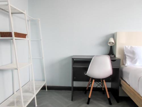 a bedroom with a bed and a desk and a chair at 420 Hostel - Ekkamai Buds & Beds in Bangkok