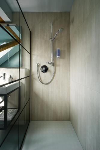 a shower in a bathroom with a sink at Ben Hogan Lodge in Owingen