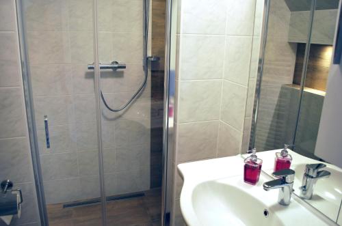 a bathroom with a shower and a sink and a shower at Gästehaus Brangshof in Willich