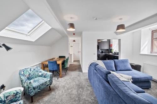 a living room with a blue couch and a table at Prime Central Living 5-Bedroom 3-Bath Spacious House in Montrose