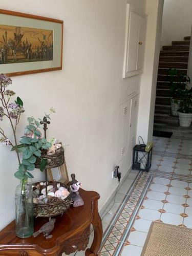 a hallway with a table with a vase of flowers on it at Villa guest suite near Vienna in Perchtoldsdorf