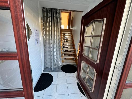 a hallway with a staircase in a house at ECOVILLA - Natur pur in Friedersdorf