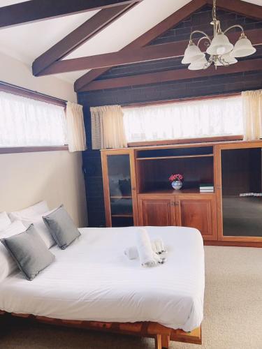 a bedroom with two beds and a ceiling at Sunny garden house in Lenah Valley
