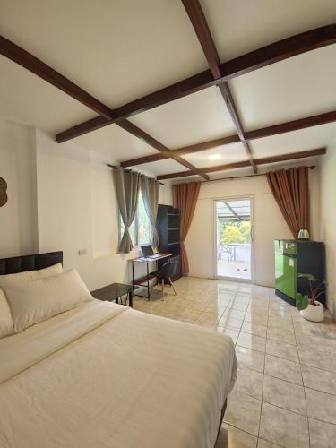 a bedroom with a bed and a desk in it at Koh Mak Garden View for Family&Friends in Ko Mak
