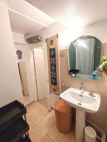 a bathroom with a sink and a mirror at Le Sunshine - 2 people studio & Todler - Cosy - Porte des Lilas in Les Lilas