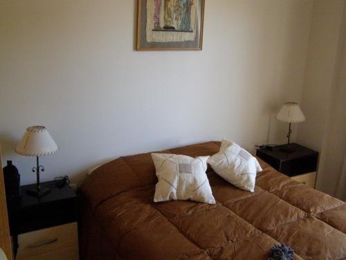 a bedroom with a bed with two pillows on it at Apartamento Edificio Atlantis I in Villa Carlos Paz