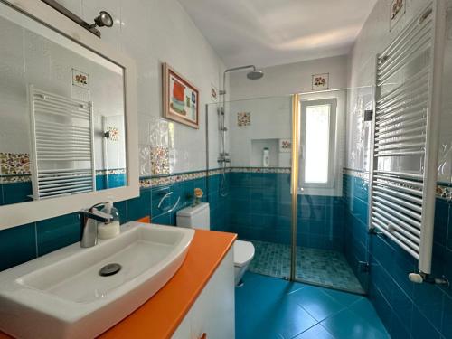 a blue and white bathroom with a sink and a shower at Wonderful private villa near beach with sea views in Marbella