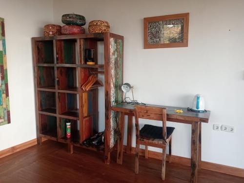 a desk and book shelf next to a table and chair at Liri Villa - 4 BRs - Ocean, Valley view in Temukus