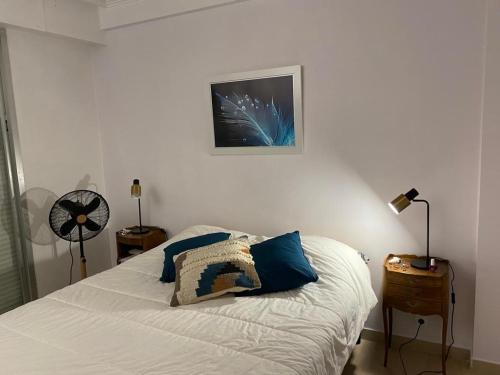 une chambre avec un lit avec des oreillers bleus dessus dans l'établissement superbe 2 pièces à Cannes vue imprenable, à Cannes